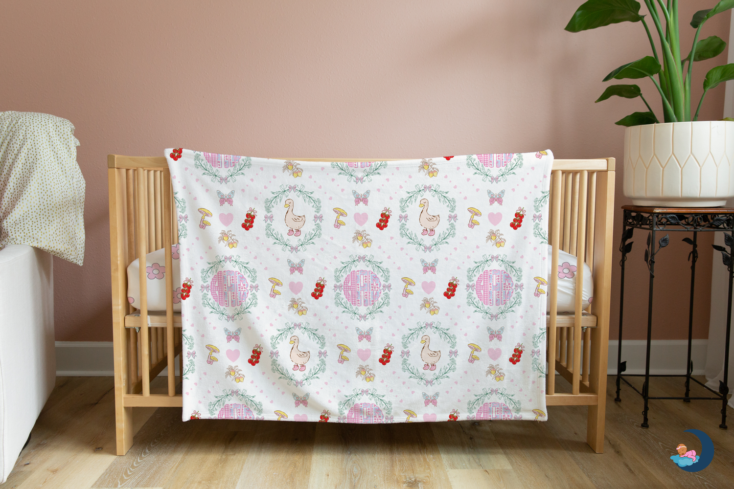 Baby crib with a colorful patterned blanket draped over it in a nursery setting.